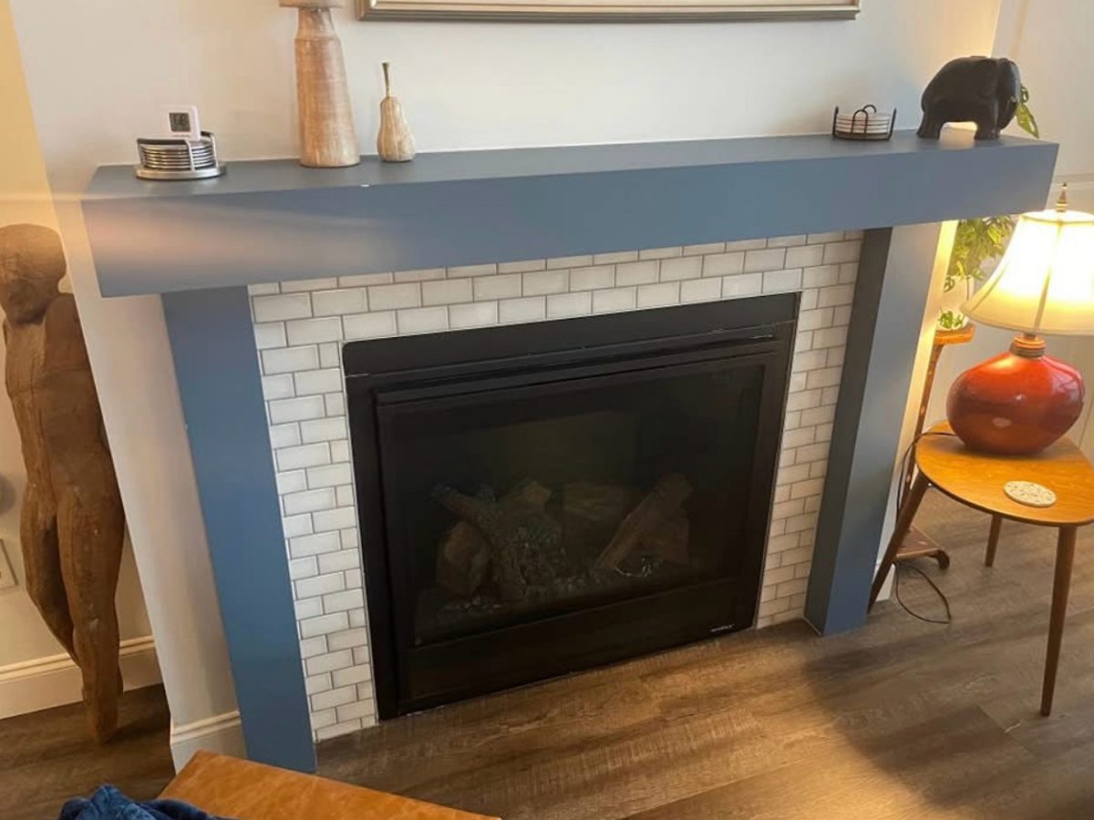 Before: white subway tile fireplace with a painted wood mantel